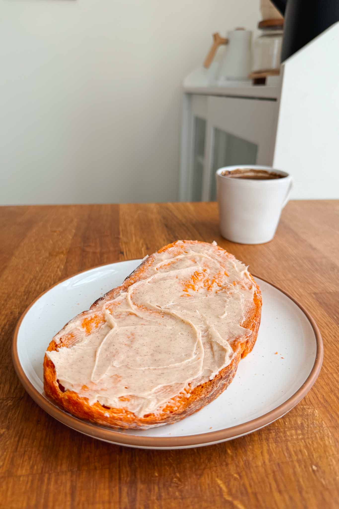 Slice of pumpkin bread with a generous layer of cinnamon honey butter.