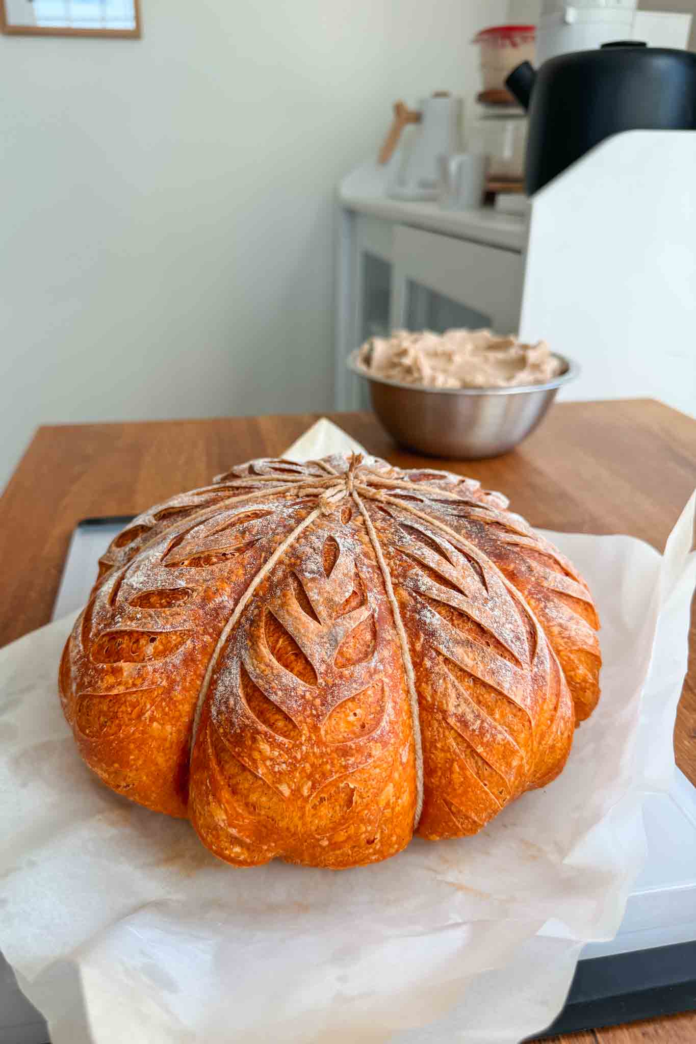 Baked pumpkin shaped sourdough bread with strings still attached. 