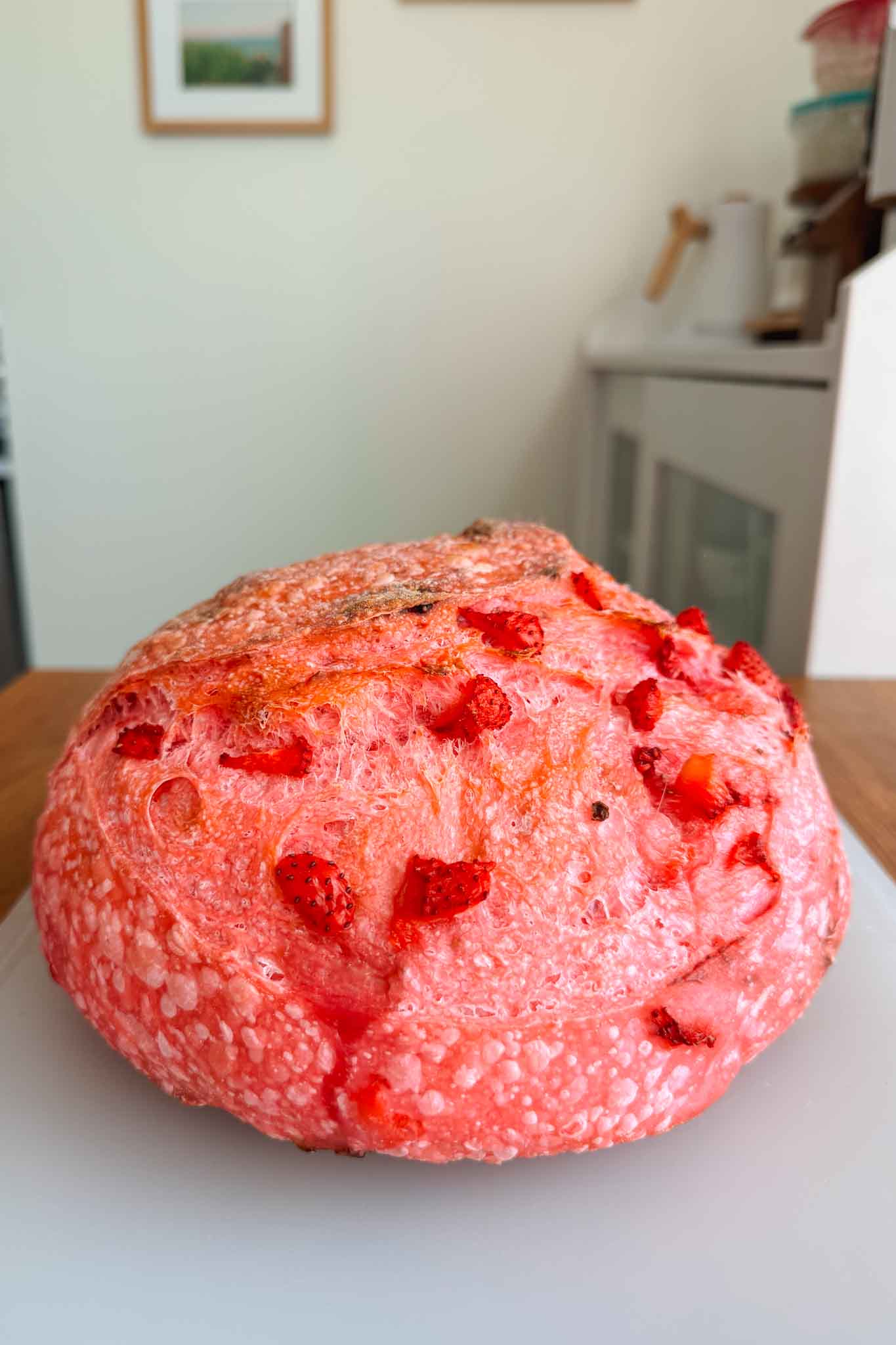 Baked strawberry sourdough bread on cutting board