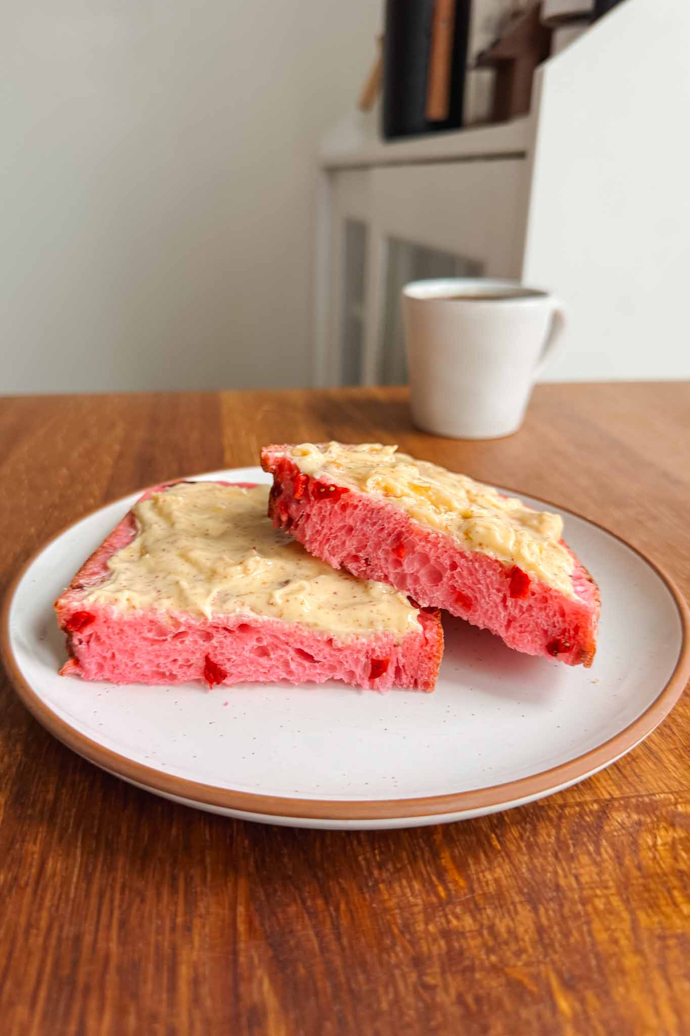 Slices of strawberry sourdough bread with butter on plate. 