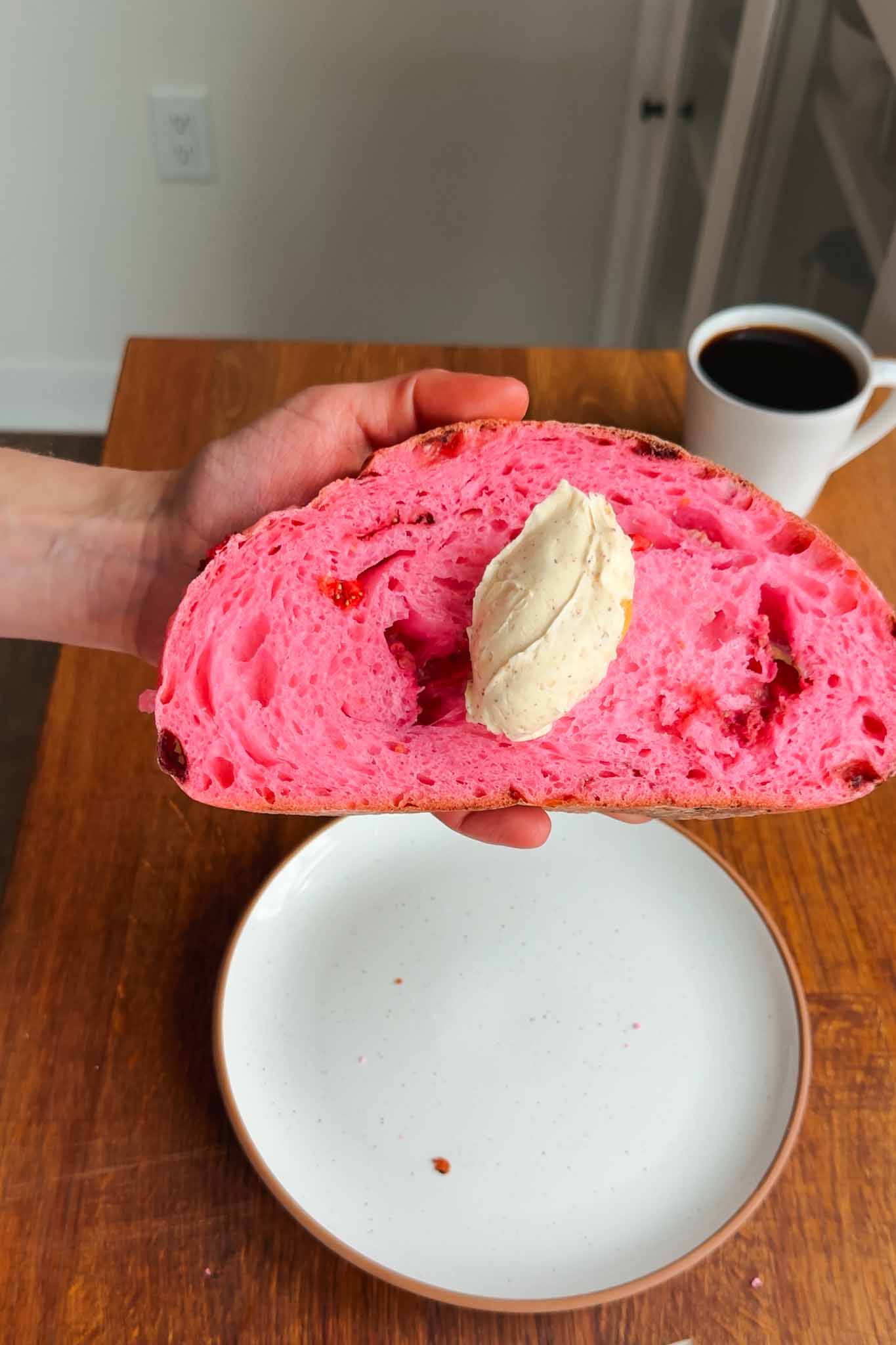 Slice of strawberry sourdough bread with a dollop of butter.