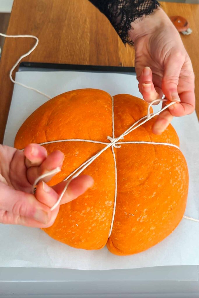 Typing pumpkin shaped dough with third string. 