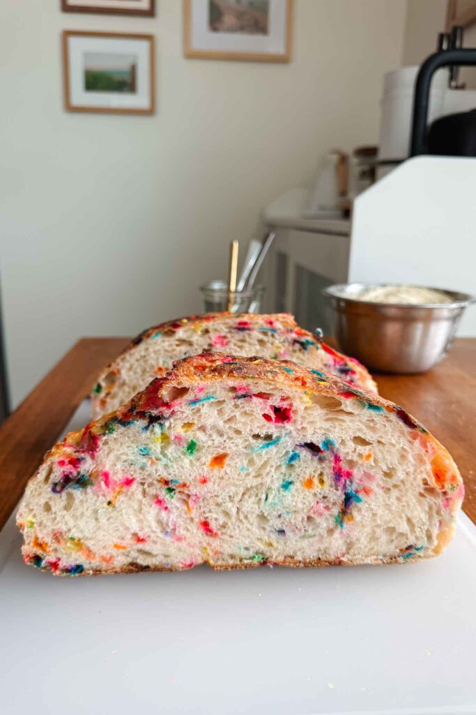 Funfetti sourdough bread halves on cutting board