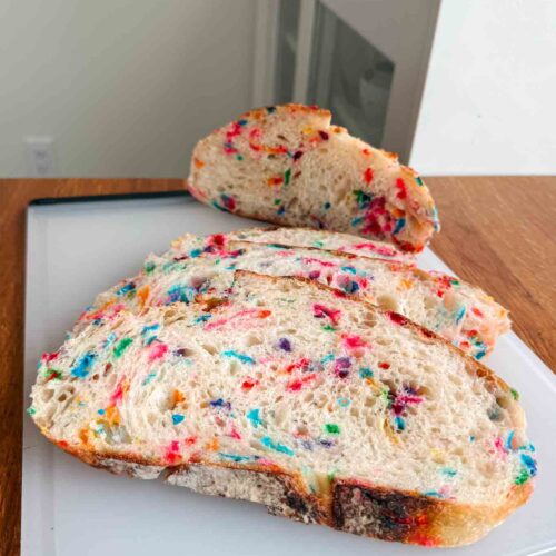 Funfetti sourdough bread slices on cutting board